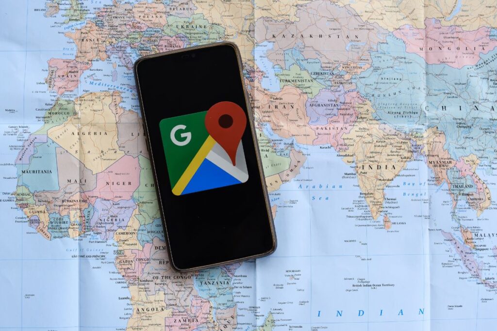 Smartphone displaying Google Maps with a city map background
