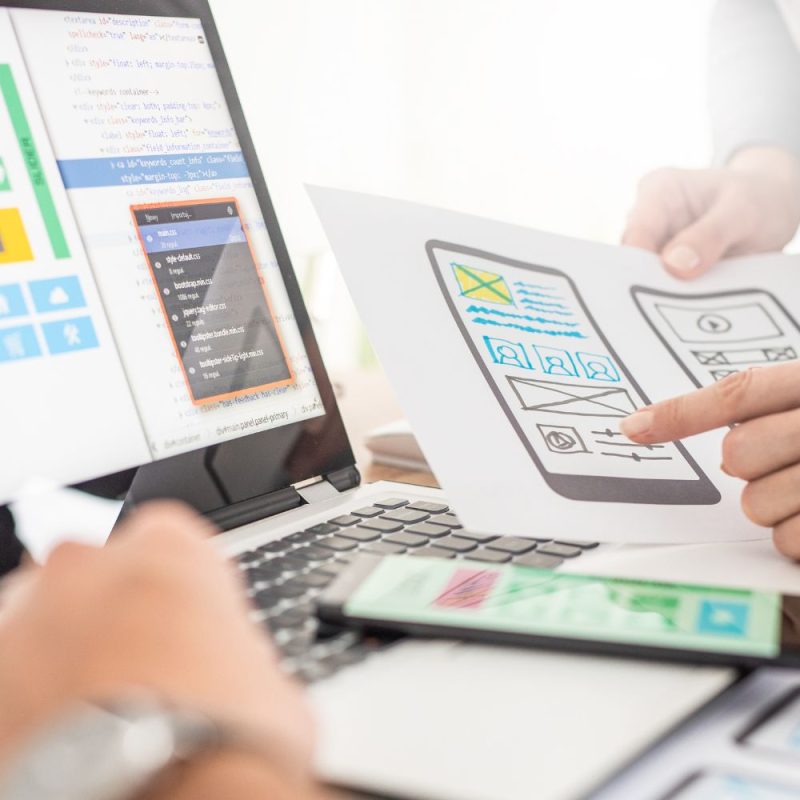 Mobile App Designers Discussing Wireframe Drafts
