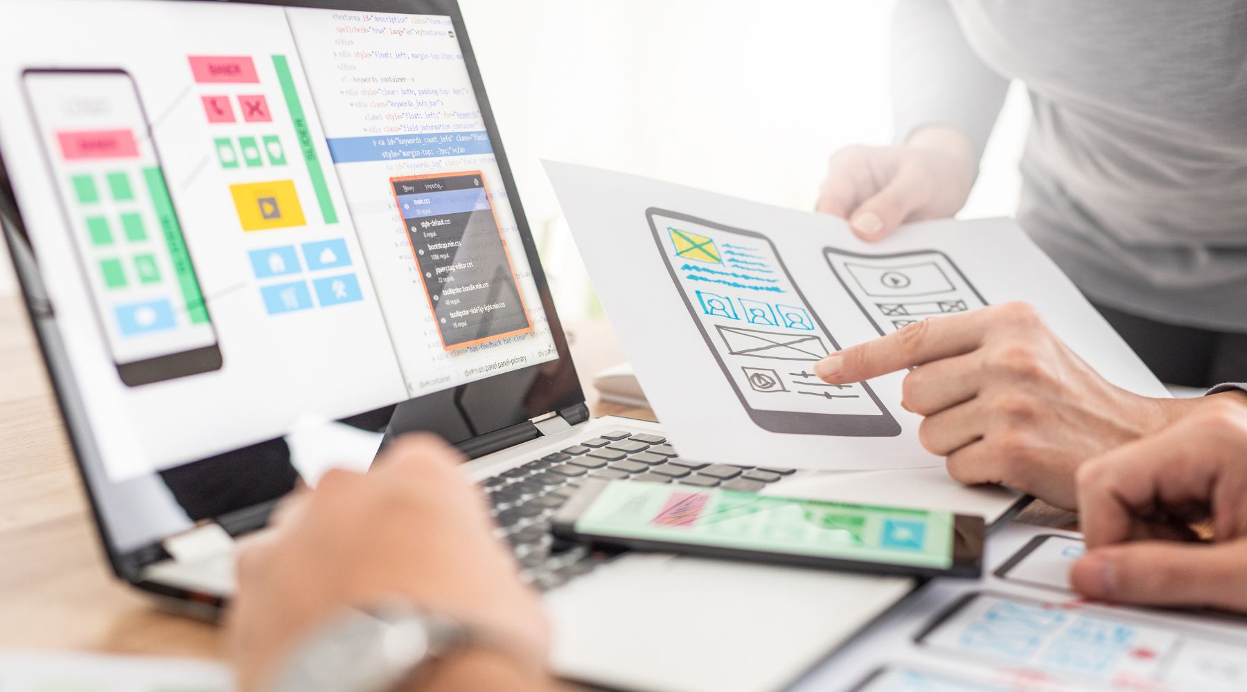 Mobile App Designers Discussing Wireframe Drafts