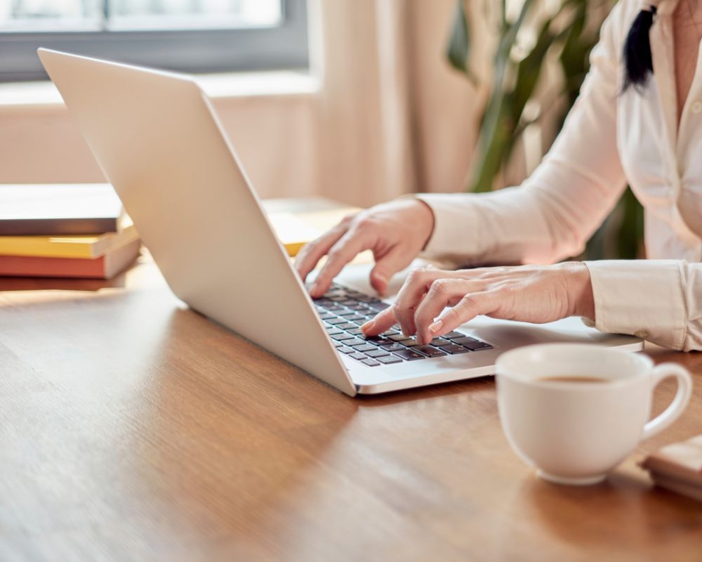 working woman typing on laptop