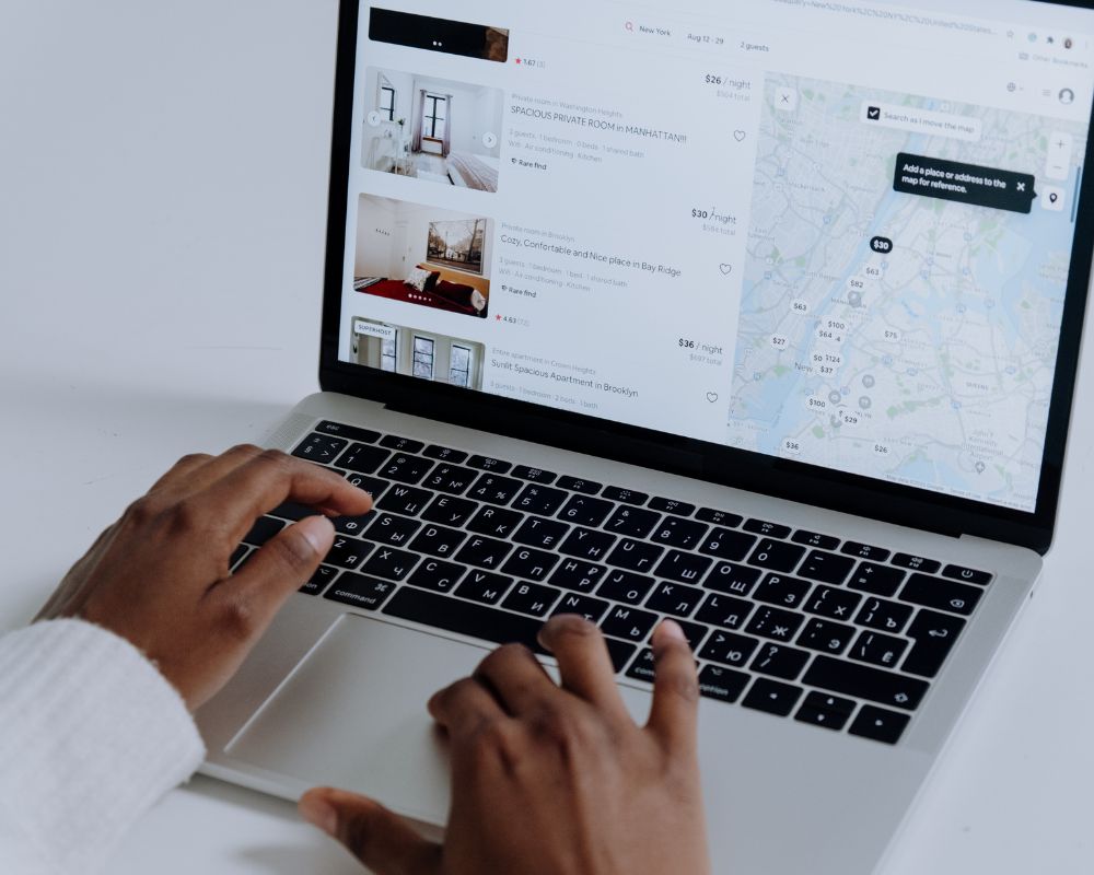 Person Using Macbook Pro on White Table